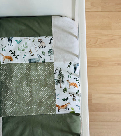 Ready to go, lightly quilted style blanket, green and beige forest animals. Soft green minky backing
