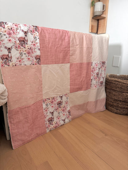 Ready to go, lightly quilted style blanket with pink and yellow floral deer print. Soft ivory minky backing