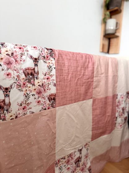 Ready to go, lightly quilted style blanket with pink and yellow floral deer print. Soft ivory minky backing