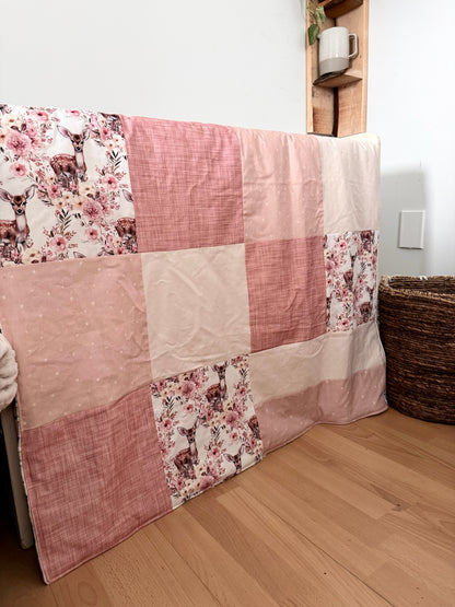 Ready to go, lightly quilted style blanket with pink and yellow floral deer print. Soft ivory minky backing